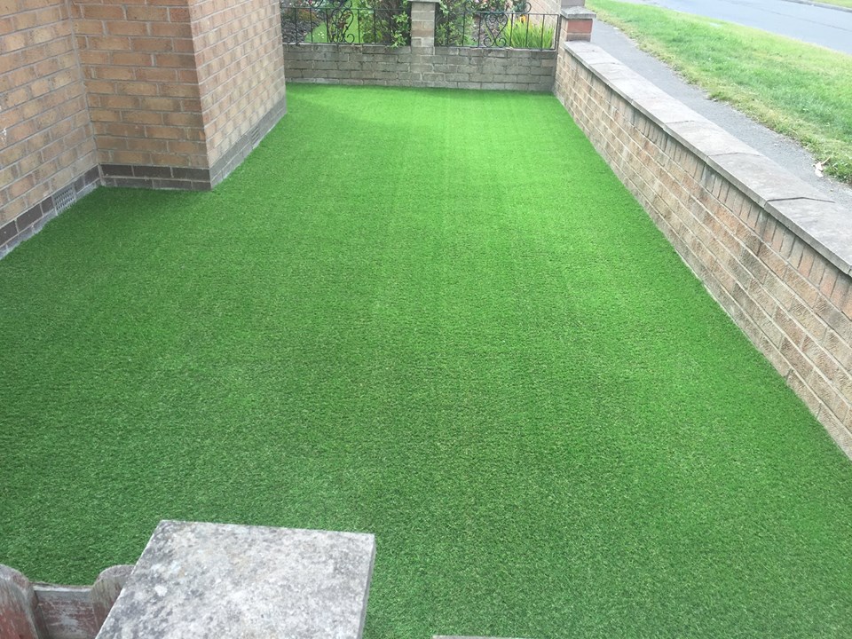pet artificial grass laid at the side of a house